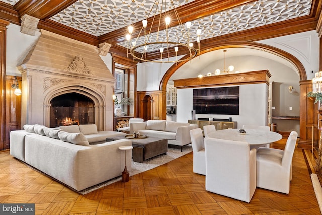 living room featuring a chandelier, a high ceiling, parquet floors, and a premium fireplace