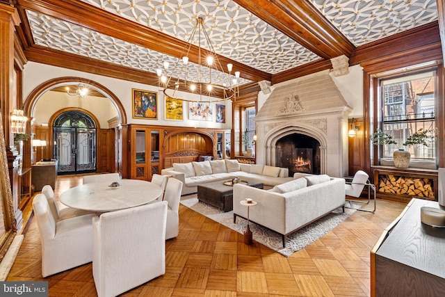 living room featuring a high ceiling, light parquet floors, french doors, and a healthy amount of sunlight