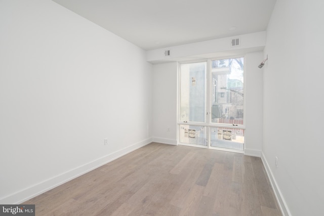 empty room featuring plenty of natural light and light wood-type flooring