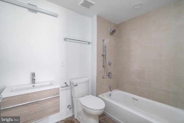 full bathroom with vanity, tiled shower / bath combo, and toilet