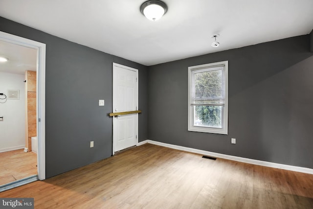 spare room featuring light hardwood / wood-style floors