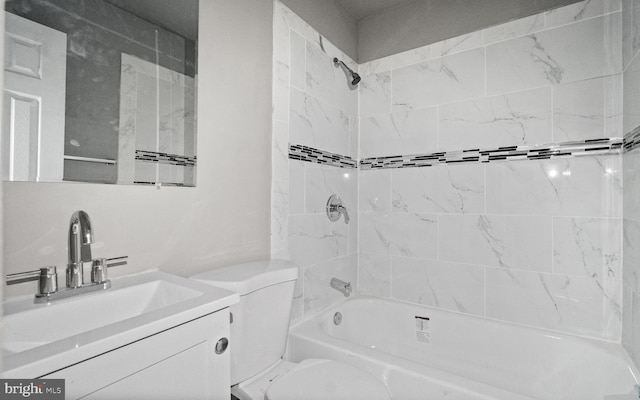 full bathroom featuring vanity, toilet, and tiled shower / bath combo