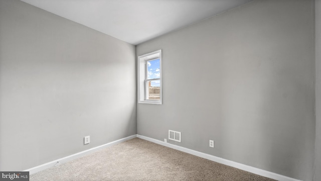 unfurnished room featuring carpet flooring