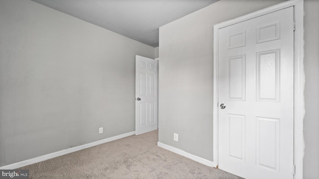 unfurnished bedroom featuring light carpet