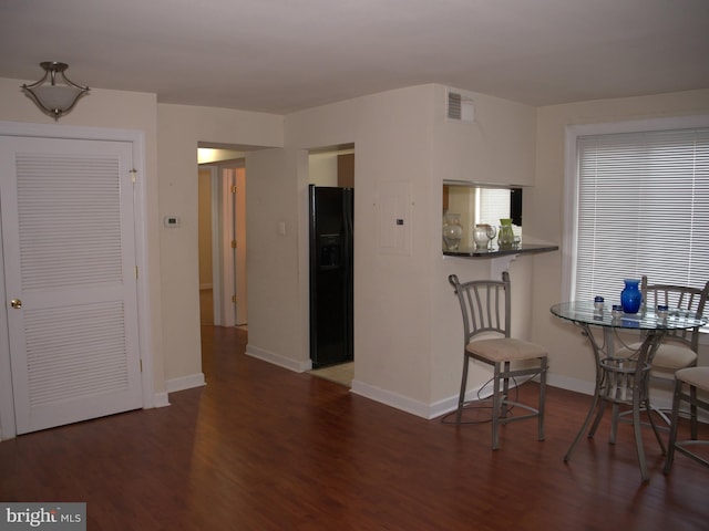 dining space featuring dark wood-type flooring