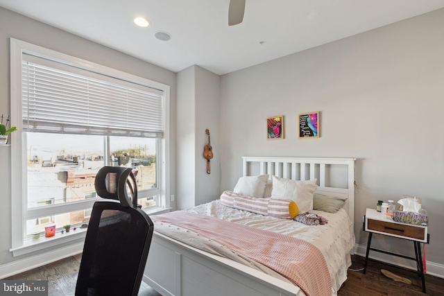 bedroom with ceiling fan and dark hardwood / wood-style floors