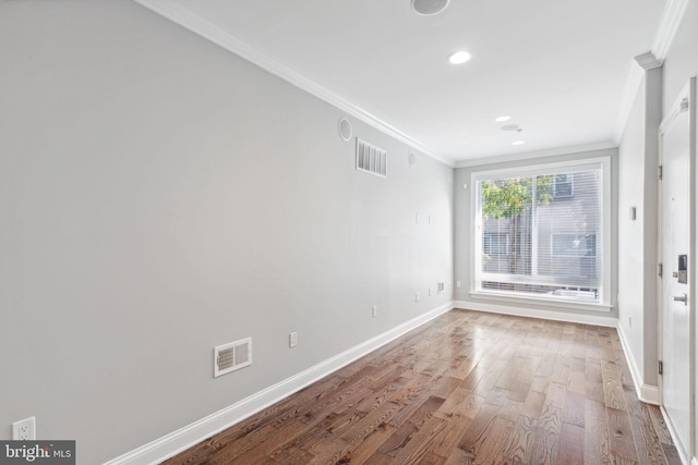 unfurnished room featuring hardwood / wood-style flooring and ornamental molding