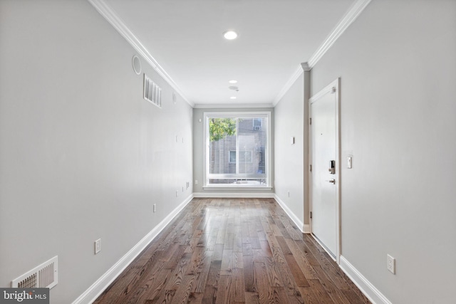 corridor with dark hardwood / wood-style floors and ornamental molding