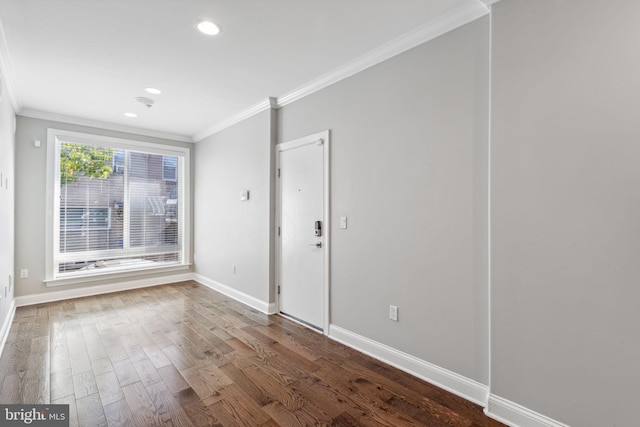 unfurnished room featuring wood-type flooring and crown molding