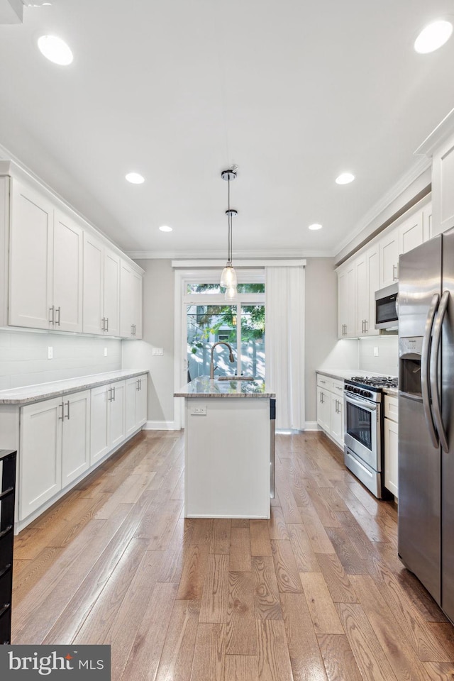 kitchen featuring light hardwood / wood-style flooring, white cabinets, and appliances with stainless steel finishes