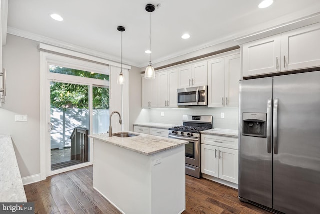 kitchen with light stone countertops, appliances with stainless steel finishes, white cabinetry, and hanging light fixtures