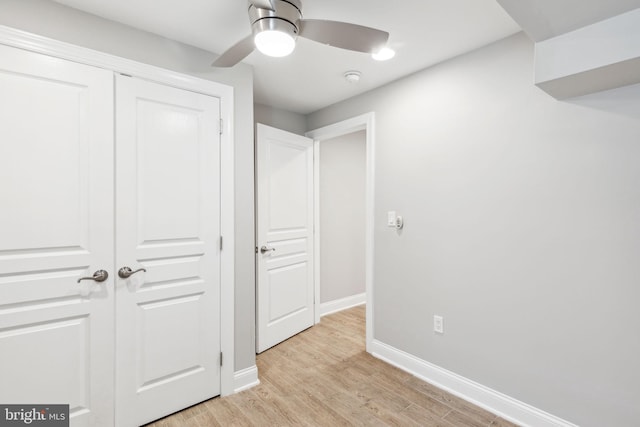 unfurnished bedroom featuring a closet, light hardwood / wood-style flooring, and ceiling fan