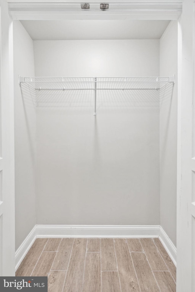 spacious closet featuring hardwood / wood-style flooring