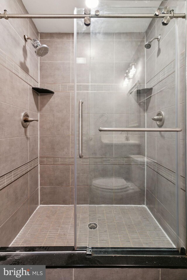 1922 S Lambert St, Philadelphia, PA 19145 - laundry room with stacked washing machine and dryer and wood finished floors