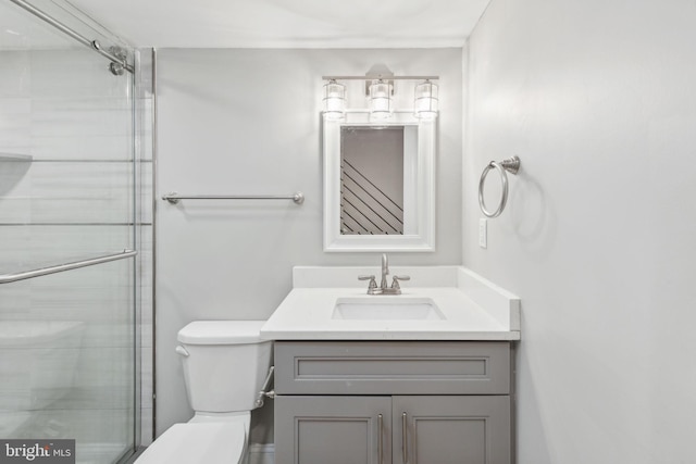 bathroom with vanity, toilet, and an enclosed shower