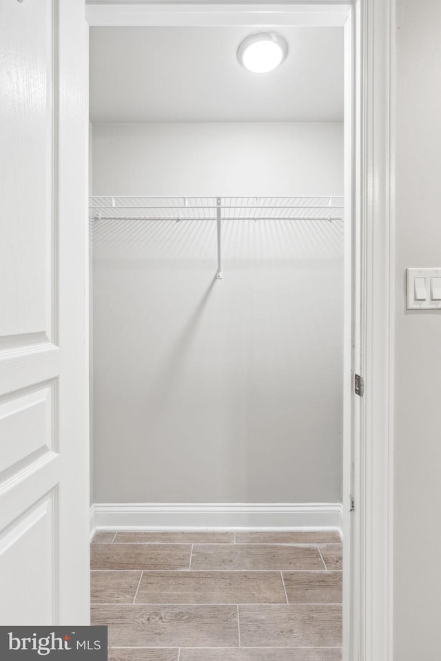 walk in closet with light wood-type flooring