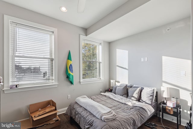 bedroom with ceiling fan and dark hardwood / wood-style flooring