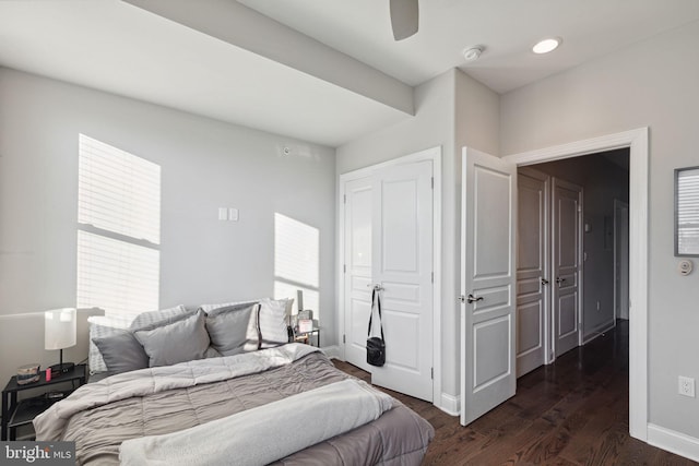 bedroom with ceiling fan, a closet, and dark wood-type flooring