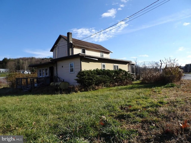 111 Birch Run Rd, Snow Shoe, PA 16874 - view of property exterior featuring a chimney and a yard