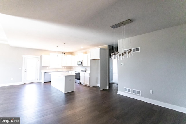 kitchen featuring a center island, hanging light fixtures, range with electric stovetop, dark hardwood / wood-style flooring, and white cabinetry