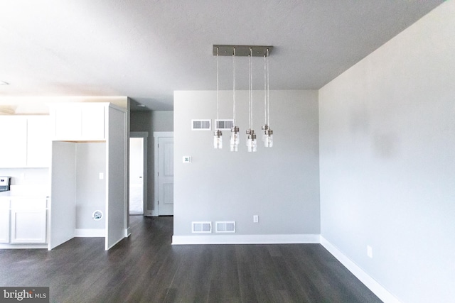 unfurnished dining area with dark hardwood / wood-style floors