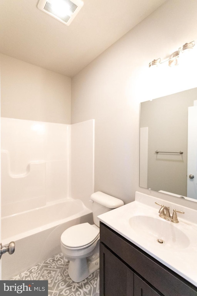 full bathroom with tile patterned floors, vanity, toilet, and washtub / shower combination