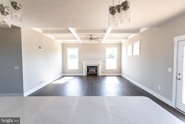 unfurnished living room with ceiling fan, beam ceiling, dark hardwood / wood-style flooring, and coffered ceiling