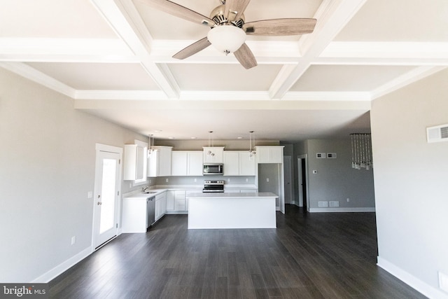 kitchen featuring white cabinetry, a center island, stainless steel appliances, and coffered ceiling