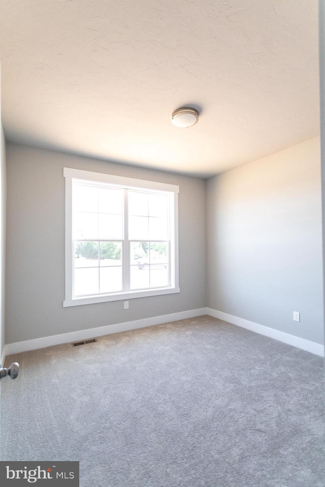 unfurnished room featuring carpet flooring