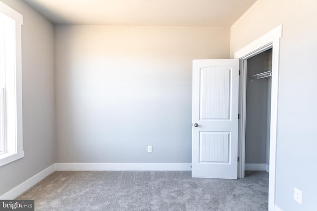 unfurnished bedroom featuring carpet floors and a closet