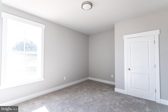 unfurnished room with carpet floors