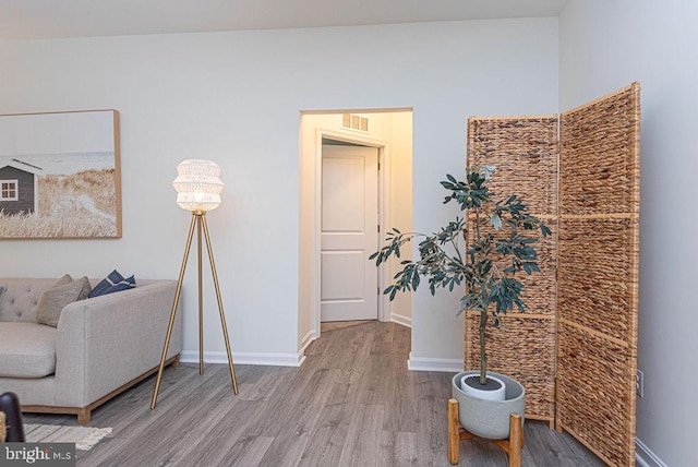 living area with hardwood / wood-style floors