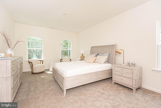 bedroom featuring light carpet