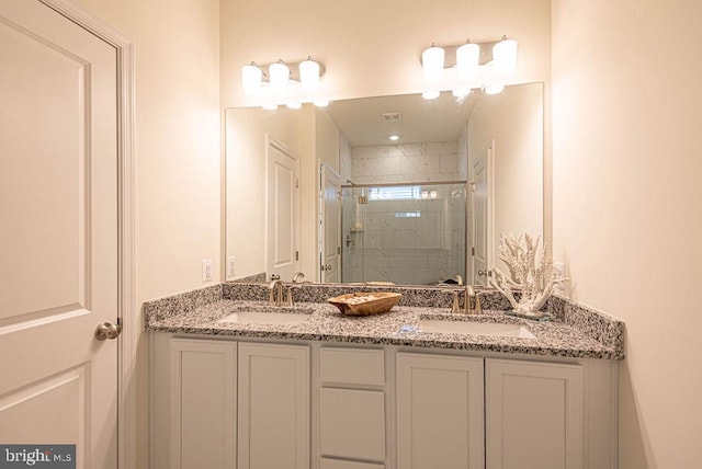 bathroom featuring vanity and a shower with door