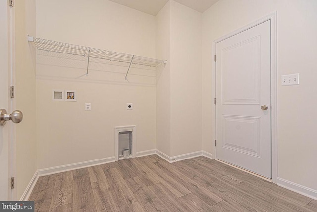 laundry area with hookup for an electric dryer, washer hookup, and light hardwood / wood-style floors