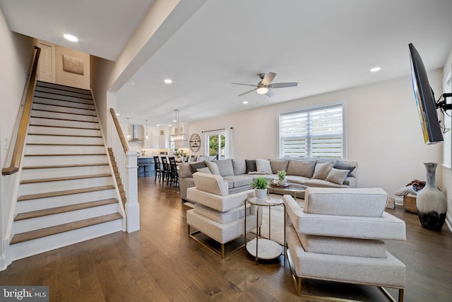 living room featuring ceiling fan and dark wood-type flooring