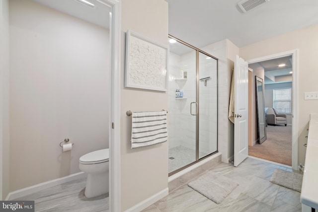 bathroom with toilet and a shower with door