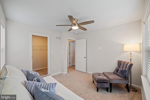 interior space with ceiling fan and light colored carpet