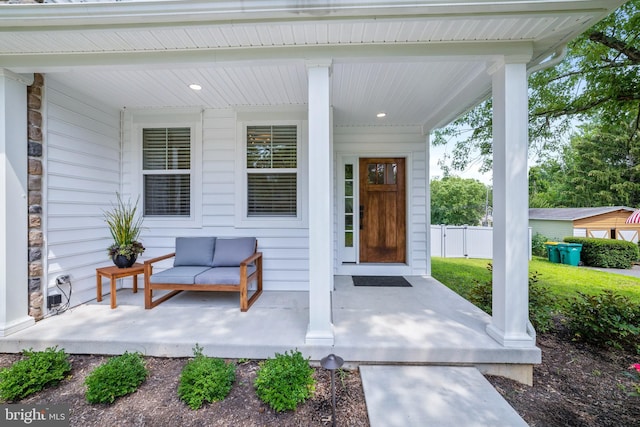 view of exterior entry with covered porch