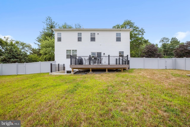 back of house with a yard and a deck