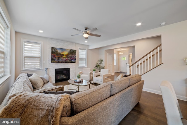 living room featuring ceiling fan and dark hardwood / wood-style floors