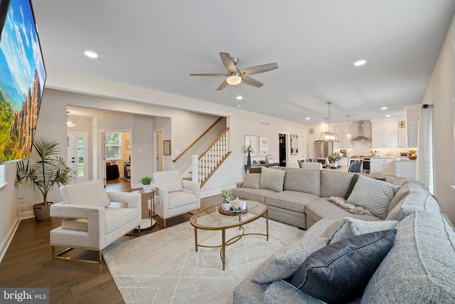 living room featuring ceiling fan and hardwood / wood-style floors