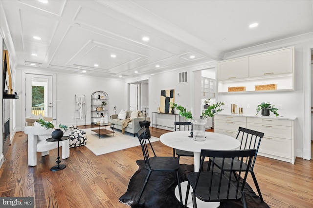 bathroom featuring plus walk in shower, a notable chandelier, vanity, tile walls, and ornamental molding