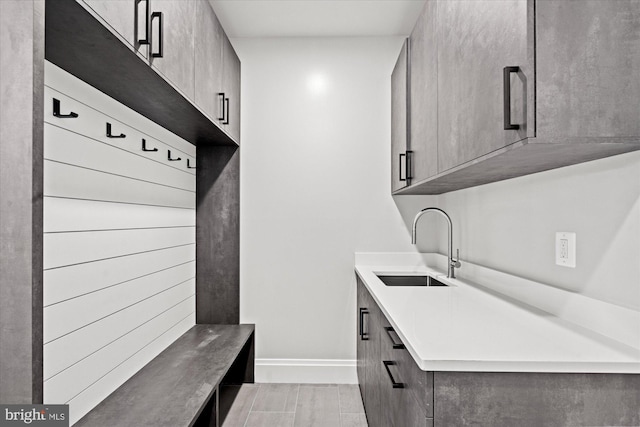 mudroom featuring sink and light hardwood / wood-style flooring