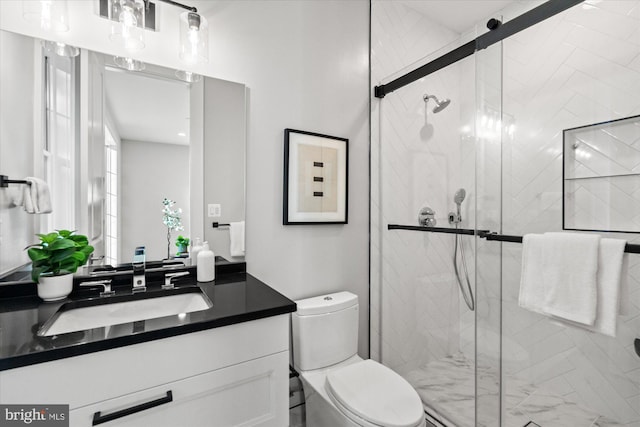 bathroom with a shower with door, vanity, and toilet