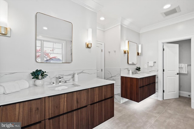 bathroom featuring tile patterned flooring, vanity, and crown molding