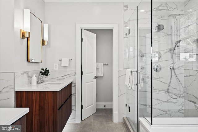 bathroom featuring tile patterned floors, vanity, and a shower with door