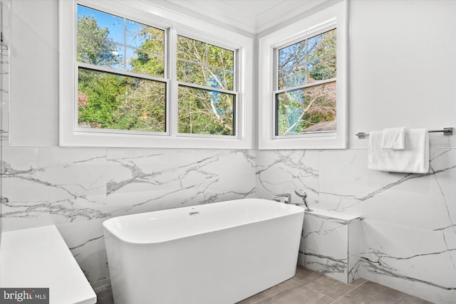 bathroom with a washtub and tile walls