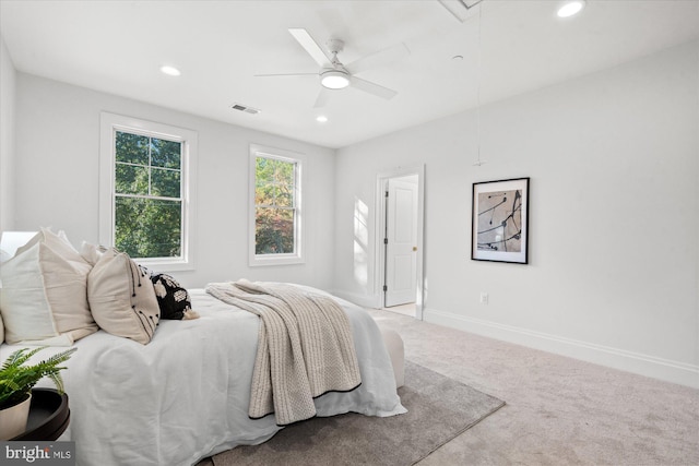 bedroom with ceiling fan and light carpet