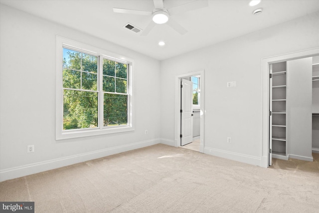 unfurnished bedroom featuring light colored carpet and ceiling fan